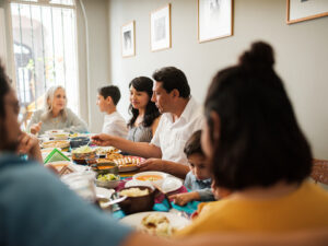 A mexican family talking and eating tasty mexican food during a meal.